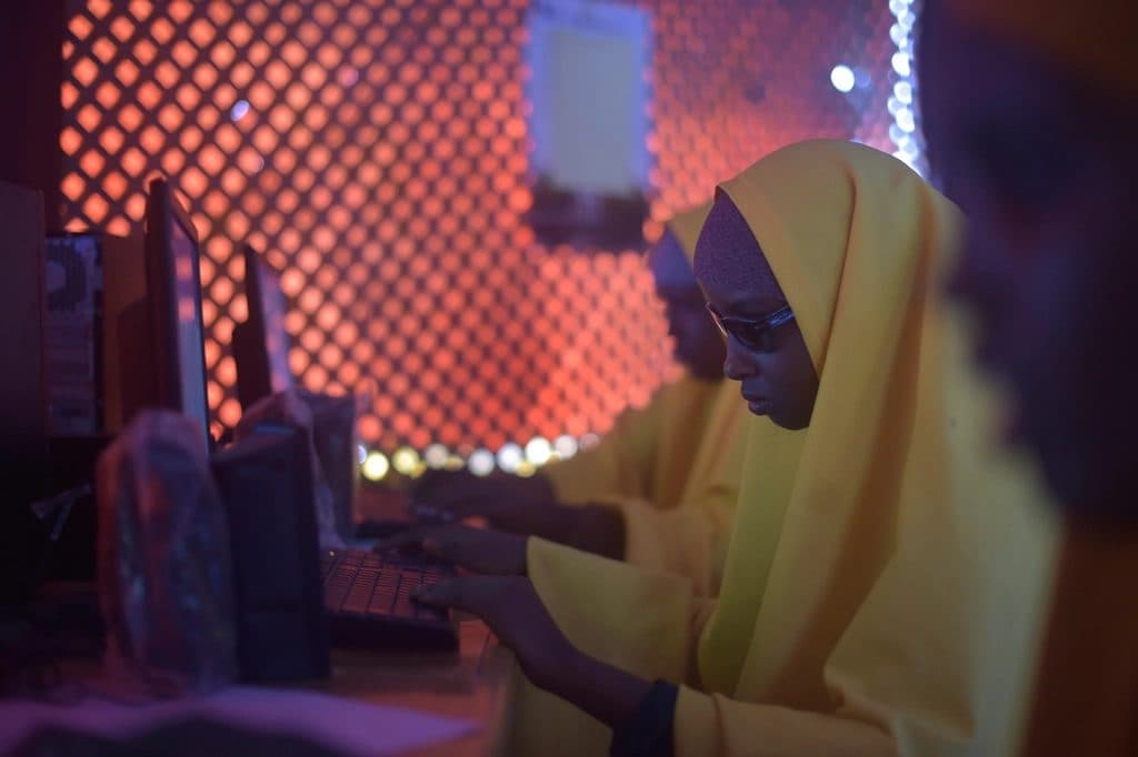 A woman working at a computer at night